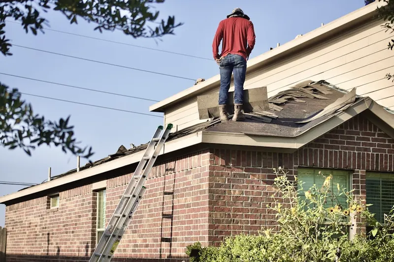 Professional roofer working on a residential roof in North Gage